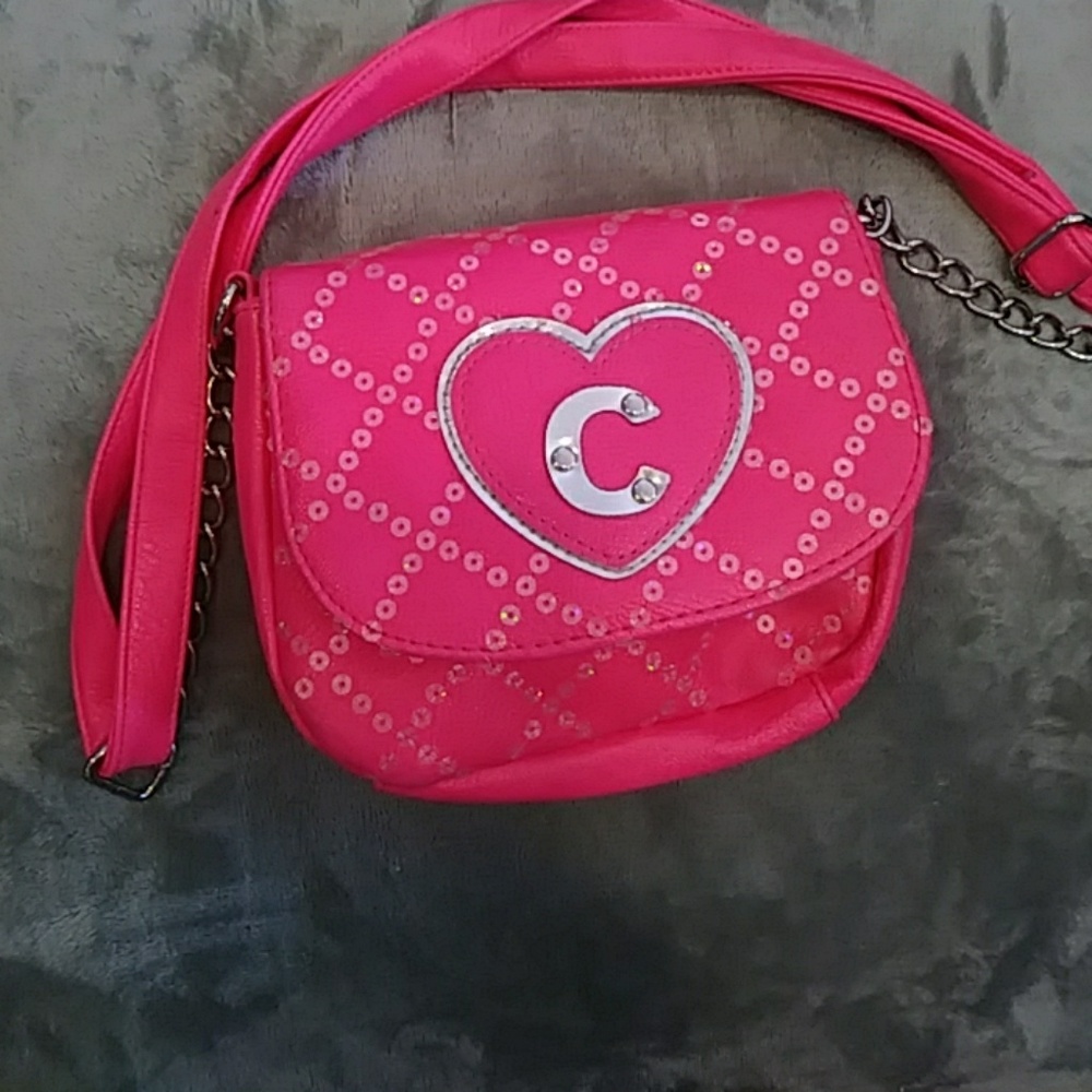 Justice bag in pink with a sliver c on the bag